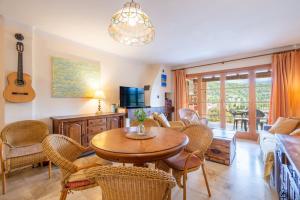 a living room with a table and chairs at Montemar 34 in Port de Soller