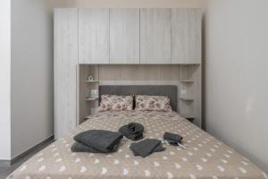 a bedroom with a bed with two pillows at Casa Andrea in Assemini