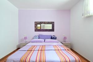 a bedroom with a large bed with two night stands at Casa Spaziosa in Bari Sardo