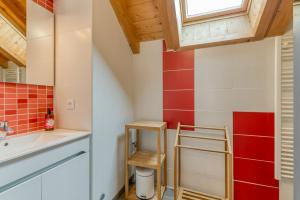 a bathroom with a sink and red and white tiles at Chalet Arvina in Saint-Jean-dʼArves +133 photos