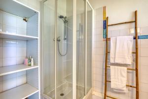 a shower with a glass door in a bathroom at Mas des Cypres - Mazet 4 in Saintes-Maries-de-la-Mer