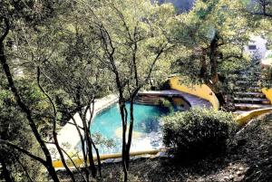a water slide in a park with a swimming pool at Casa Lago - Selão da Eira in São Teotónio
