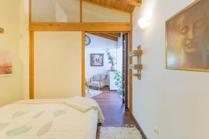 a bedroom with a bed and a door to a hallway at Casa Lago - Selão da Eira in São Teotónio +20 photos