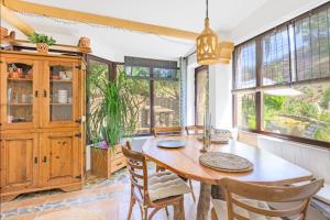 a dining room with a wooden table and chairs at Casa Lago - Selão da Eira in São Teotónio