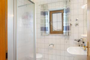 a bathroom with a shower and a sink at Ferienwohnungen Hackerhof in Bad Füssing +14 photos