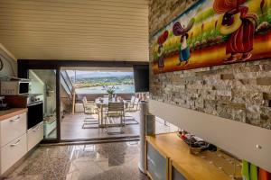 a kitchen and dining room with a view of the ocean at Residence Gigi Complex Manerba in Manerba del Garda