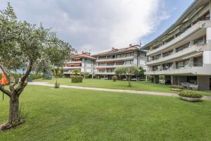 an apartment building with a lawn in front of it at Residence Gigi Complex Manerba in Manerba del Garda