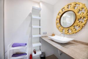 a bathroom with a sink and a mirror at Casa Rewa in Port d'Alcudia +13 photos