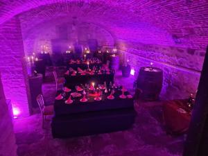 a room with purple lighting and a table in a cave at Marktplatz Ferienwohnung in Alsfeld