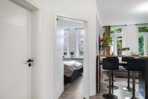 a room with a table and a bedroom with a bed at Marktplatz Ferienwohnung in Alsfeld +24 photos