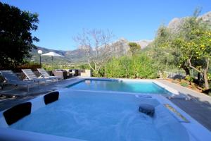 a swimming pool with mountains in the background at Sa Vinya de Son Bou in Sóller