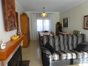 a living room with a couch and a dining room at Villa Rocamar in L'Escala