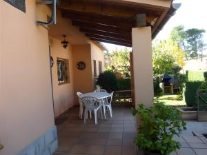 a patio with a table and chairs on it at Villa Rocamar in L'Escala