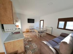 a kitchen and a living room with a couch and a table at Casa Pedro in Vélez-Rubio