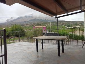 a table on a patio with a view of a mountain at Casa Pedro in Vélez-Rubio