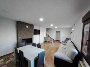 a living room with a couch and a table and a fireplace at Casa Pedro in Vélez-Rubio
