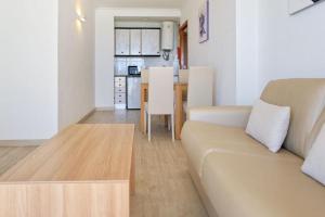 a living room with a couch and a table at R2 Cala Millor in Cala Millor