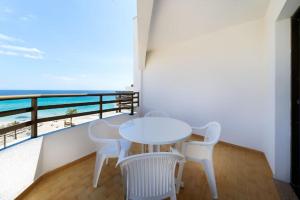 a white table and chairs on a balcony with the beach at R2 Cala Millor in Cala Millor +23 photos