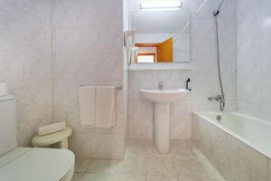 a white bathroom with a sink and a toilet at R2 Cala Millor in Cala Millor