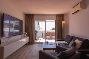 a living room with a couch and a flat screen tv at Casa Lagos - 046 in Caleta De Velez