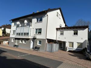 a large white building on the side of a street at Ferienwohnungen Golsong in Thaleischweiler-Fröschen