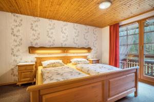 a bedroom with a wooden bed and a window at Vogtshof in Bad Rippoldsau-Schapbach
