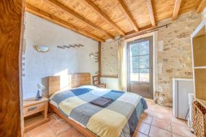 a bedroom with a large bed and a window at Le Moulin in Guizengeard +18 photos