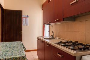 a kitchen with a sink and a stove in it at Appartamento C - Le Terrazze in Ribera
