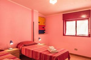 a room with two beds and a window at Appartamento C - Le Terrazze in Ribera