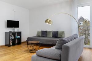 a living room with a couch and a chair at Fewo im Eichengrund in Rheinhausen