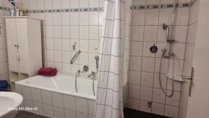 a bathroom with a shower and a bath tub with a tub at Haus Zeller in Klettgau +4 photos
