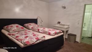 a bedroom with a bed with two pillows on it at Haus Zeller in Klettgau