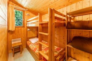 a bedroom with bunk beds in a log cabin at Gite Thym in Mirabel-aux-Baronnies +17 photos
