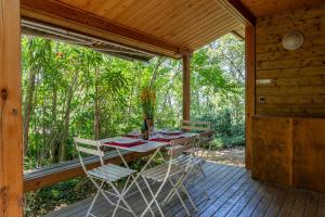 a wooden porch with a table and chairs on it at Gite Thym in Mirabel-aux-Baronnies
