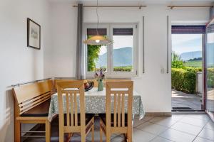 a dining room with a table and chairs and a window at Georgshof - Eppan in Appiano sulla Strada del Vino