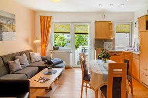 a living room with a couch and a table at Huus Nördernee 1 in Norderney