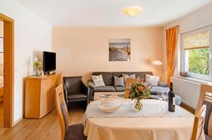 a living room with a table and a couch at Huus Nördernee 1 in Norderney