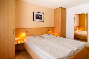 a bedroom with a large white bed in it at Huus Nördernee 1 in Norderney