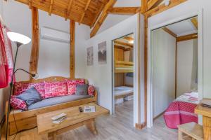 a living room with a couch and a bed at Camping L'imprévu in Vaulnaveys-le-Bas +291 photos