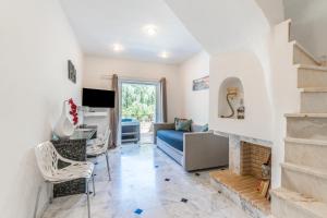 a living room with a couch and a fireplace at Doliva Studio Anthi private jacuzzi in Agios Gordios