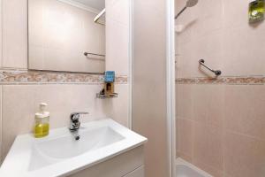 a bathroom with a sink and a mirror and a shower at Casa Canopa in Setúbal +17 photos