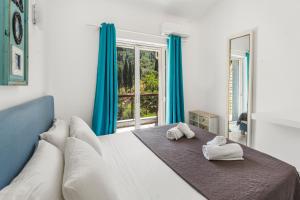 a bedroom with a large bed with towels on it at Doliva Studio Anthi private jacuzzi in Agios Gordios