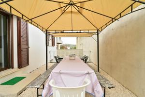 a table with a tent on a patio at Casa Spaziosa in Bari Sardo