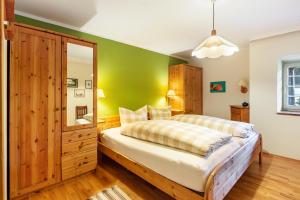 a bedroom with a large bed and a green wall at Kammbühlhof in St. Blasien