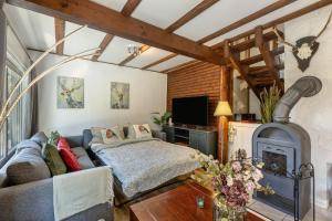 a living room with a couch and a fireplace at Ferienhaus Rotkäppchen in Frankenau