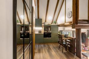 a kitchen with green cabinets and a table in it at Ferienhaus Rotkäppchen in Frankenau