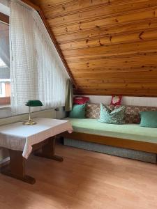 a bed in a room with a wooden ceiling at Gästehaus Schoch-Bächle in Bad Rippoldsau-Schapbach