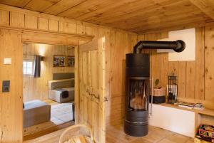 a log cabin with a wood stove in a room at Berghaus Wiesegg - Uriges Tiroler in Fügenberg