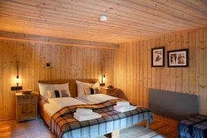 a bedroom with a bed in a wooden wall at Berghaus Wiesegg - Uriges Tiroler in Fügenberg