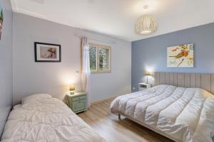 a bedroom with a bed and a window at La Cense De La Mérelie - Le Logis in Saint-Geniès +12 photos